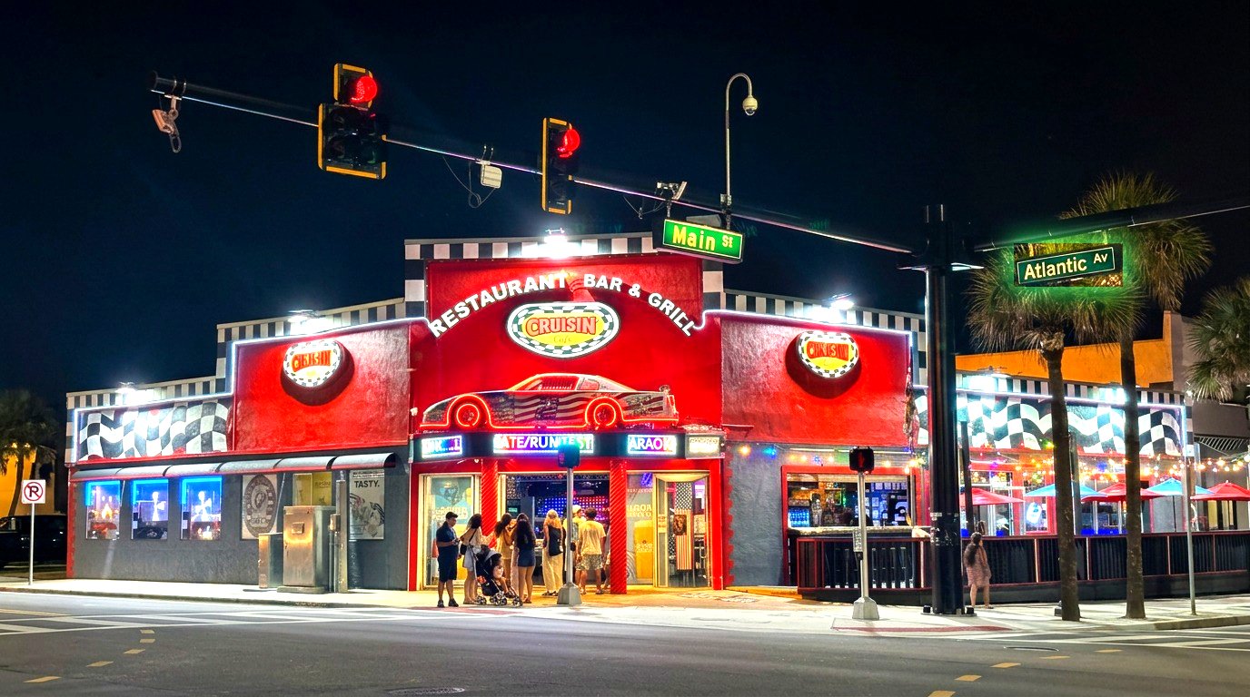 Cruisin Café restaurant, bar and grill lit up in the evening at Main Street and Atlantic Avenue, steps from Daytona Beach