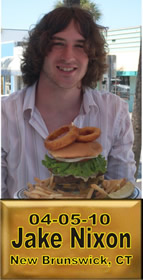 Cup Burger Challenge finisher holding their gold name plaque at Cruisin Café