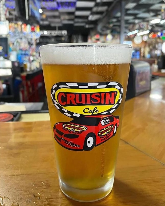 Cold draft beer in a Cruisin Café pint glass on the bar
