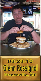 Cup Burger Challenge finisher holding their gold name plaque at Cruisin Café