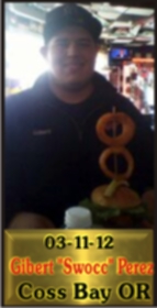 Cup Burger Challenge finisher holding their gold name plaque at Cruisin Café