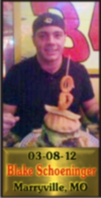Cup Burger Challenge finisher holding their gold name plaque at Cruisin Café