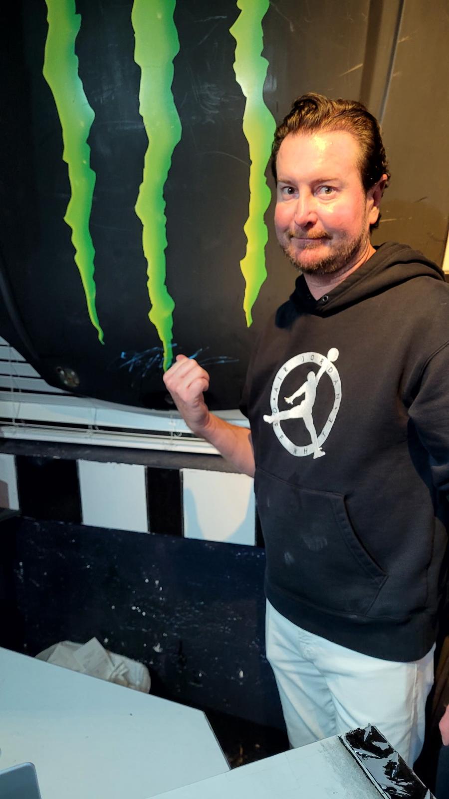 Kurt Busch, 2017 Daytona 500 winner, signs the Monster hood at Cruisin' Café.