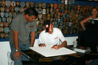 Danny with Home Depot Driver Joey Logano Signs a ceiling tile in July 2009